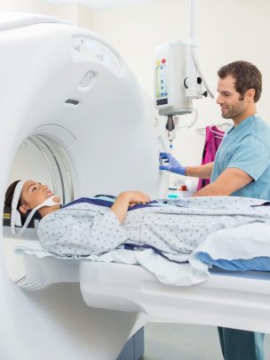 25301689 - young male nurse preparing patient for ct scan test in examination room